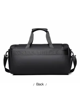 Back view detail of the black waterproof gym bag, showing sturdy handles and durable fabric.