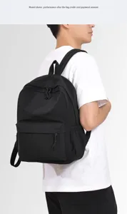 Detail shot of a black large capacity casual Japanese style backpack worn by a model.