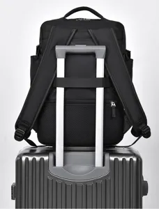 Detail view showing the convenient luggage strap on the back of the black backpack.