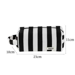 Black and white striped plush cosmetic bag with handle, portable wash storage pouch.