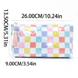 Detailed view of colorful checkerboard PVC makeup bag with cute tassel zipper pull.