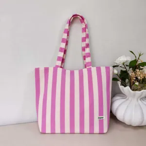 Casual striped canvas tote bag detail, stylish pink and white striped large capacity shoulder bag.