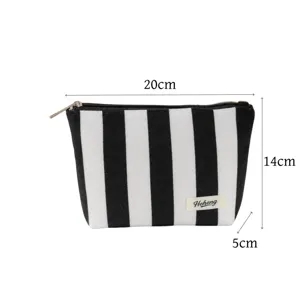 Black and white striped canvas cosmetic bag with zipper, portable makeup pouch for daily use.