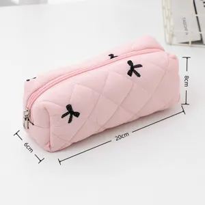 Pink quilted pencil case with cute black bow embroidery, portable makeup pouch for daily use.