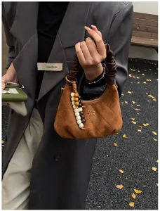 Retro suede pleated dumpling handbag for women, winter chic quilted shoulder bag with beaded charm.