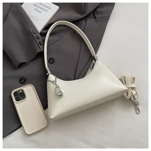 Elegant off-white shoulder bag for women, chic PU leather baguette pillow bag with strap.