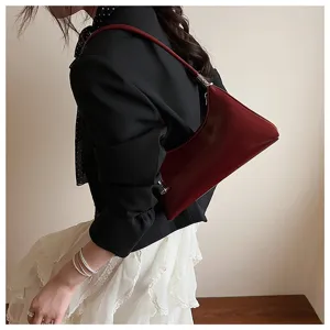 Detailed view of the vintage wine red underarm shoulder bag, stylish retro pillow design.