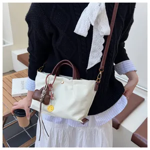 Minimalist casual women's tote bag featuring shoulder strap and cute charm decorations.