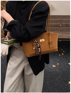Stylish brown commuting shoulder bag for women, large capacity tote with lock closure.