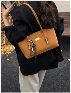 Brown PU leather shoulder tote bag with twist lock and chocolate charm for women casual commute.