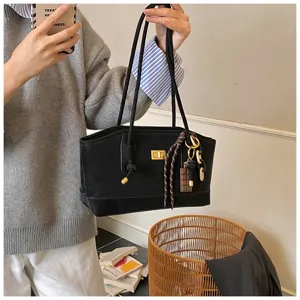 Casual black canvas tote bag with gold turn-lock and double straps for daily commute.