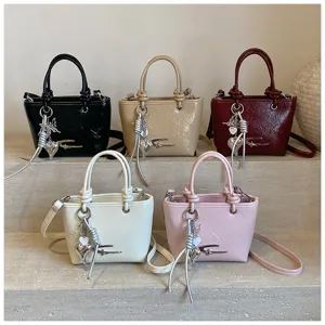 Stylish retro women's handbag set, PU leather tote and crossbody bag with chic metallic charms.