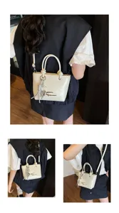 Glossy white mini crossbody bag detail view with cute metal charm and chic handle design.