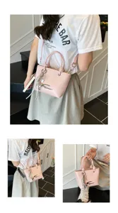 Stylish pink patent leather handbag for women, chic retro shoulder bag with metal charms.