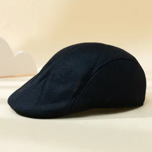 Close-up view of the black mesh ivy flat cap, showing breathable fabric and fine texture details.