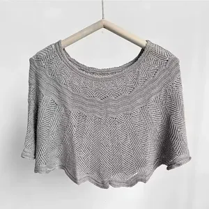 Grey knitted hollow-out cape detail, elegant summer shawl for sun protection and outfit.