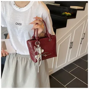 Vintage textured mini handbag for women, retro burgundy shoulder bag with charms.