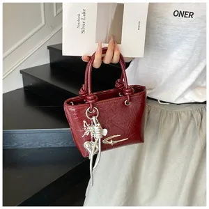 Retro vintage style women small handbag with chic metal charm detail, elegant daily fashion accessory.
