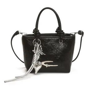 Black patent leather vintage handbag with metal charms, stylish top-handle shoulder bag.