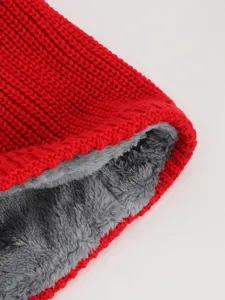 Close-up detail of red knitted fleece-lined winter neck warmer showing soft cozy texture.
