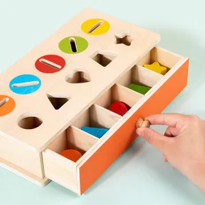 Wooden Montessori shape sorting box toy with colorful geometric blocks and sliding drawer.