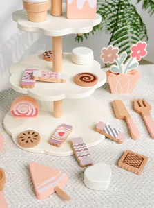 Wooden toy dessert stand detail showing cute miniature cakes and candies for kids play.