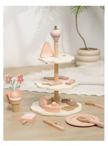 Wooden toy dessert stand detail shot showing cute miniature cakes and utensils for kids play.