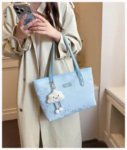 Stylish blue star print tote bag with cute cloud plush pendant for women daily casual use.