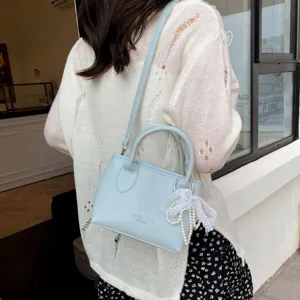 Light blue shoulder crossbody handbag for women, stylish mini tote bag with pearl lace pendant.