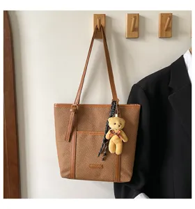 Stylish brown woven tote bag with PU leather trim and cute bear pendant for women daily commute.