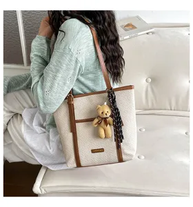 Casual canvas tote bag with brown PU trim, teddy bear pendant and striped ribbon.