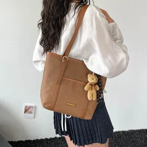 Stylish large capacity brown woven tote bag with cute bear pendant for daily commute and casual use