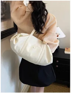 Minimalist white shoulder bag for women, versatile casual tote with spacious daily capacity.