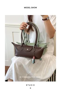 Detail view of women leather shoulder bag, stylish commuter tote with handle and chic charm.