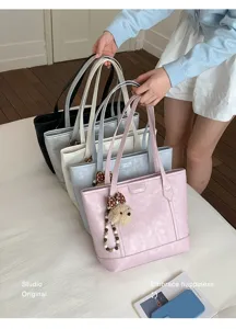 Fashion large capacity tote bag for women, trendy versatile shoulder bag with cute bear pendant.