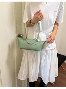 Detailed view of the elegant light green underarm shoulder bag showcasing fine craftsmanship.