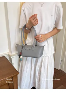 Detail shot of the stylish grey elongated shoulder bag showcasing premium texture and design.
