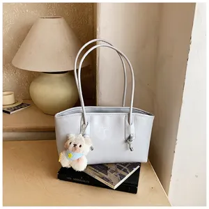 Grey shoulder tote bag for women, stylish large capacity commuter bag with cute plush bear pendant.