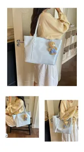 Casual minimalist blue leather tote bag with cute bear pendant for women daily commuting work use.