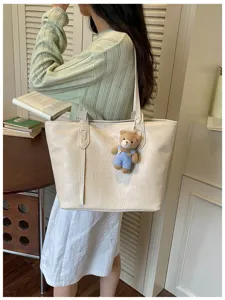 Minimalist fashion tote bag for women, large capacity shoulder bag with cute bear charm.