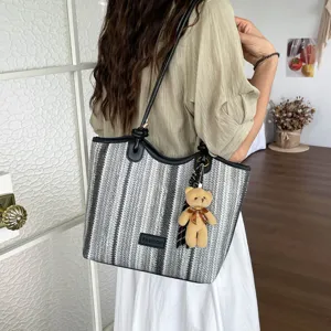 Stylish striped straw woven shoulder bag for women, casual summer beach tote with cute bear.