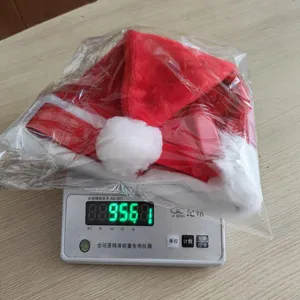 Red plush Christmas hat with white faux fur trim, soft holiday party accessory packaged.