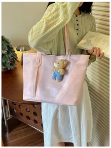 Pink PU leather tote bag for women, large capacity shoulder bag with cute bear pendant.