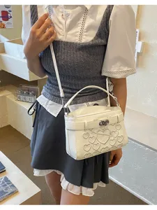 White heart quilted shoulder bag with top handle and crossbody strap, chic fashion handbag.