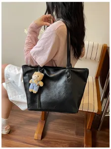Black faux leather tote bag for women, large capacity shoulder bag with cute bear pendant.