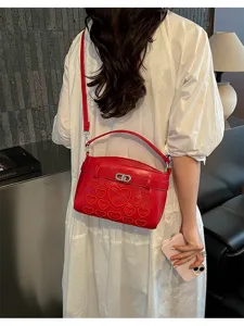 Red heart embroidered shoulder bag detail, stylish PU leather handbag with metal lock clasp.