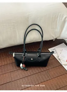 Minimalist black leather shoulder bag for women, trendy underarm bag with double handles.