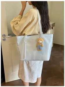 Detailed view of stylish minimalist tote bag in light blue, perfect for daily commute and casual outfits.