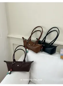 Minimalist women underarm shoulder bag, stylish casual commuting handbag with charm detail.