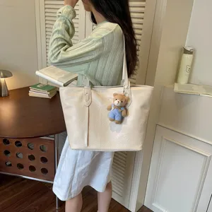 Minimalist casual women tote bag large capacity shoulder handbag with cute bear pendant.